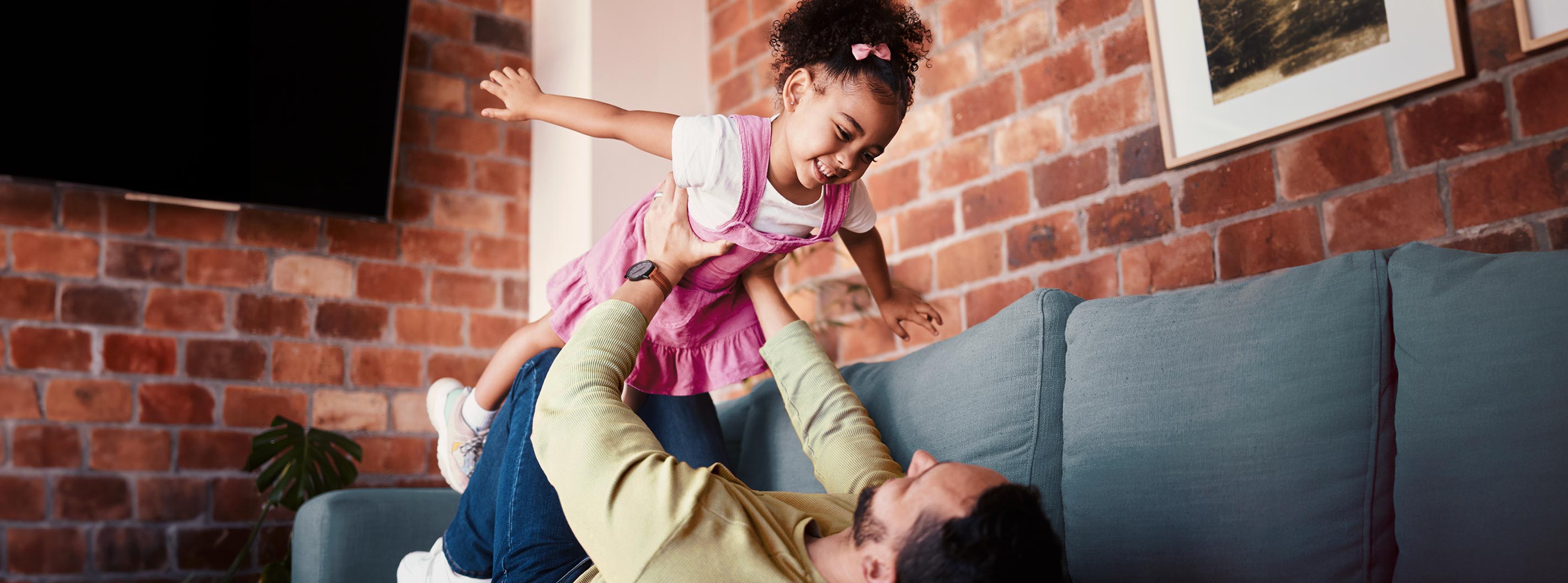 A person holding up a child