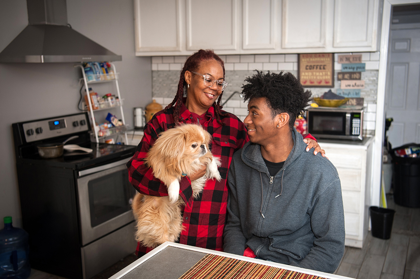 mother, son, and dog in kitchen