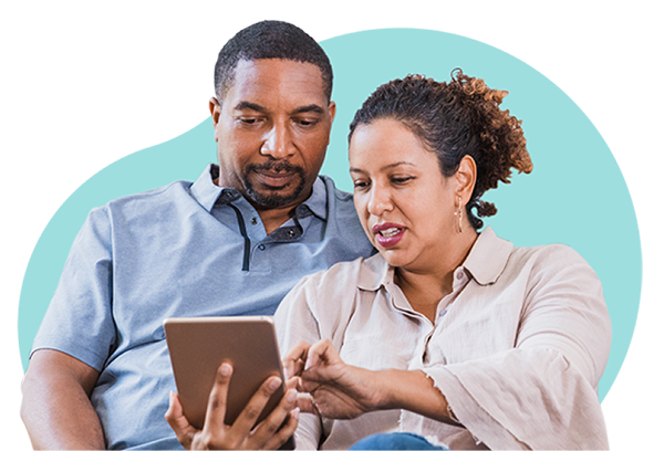 African American husband and wife look together at a tablet